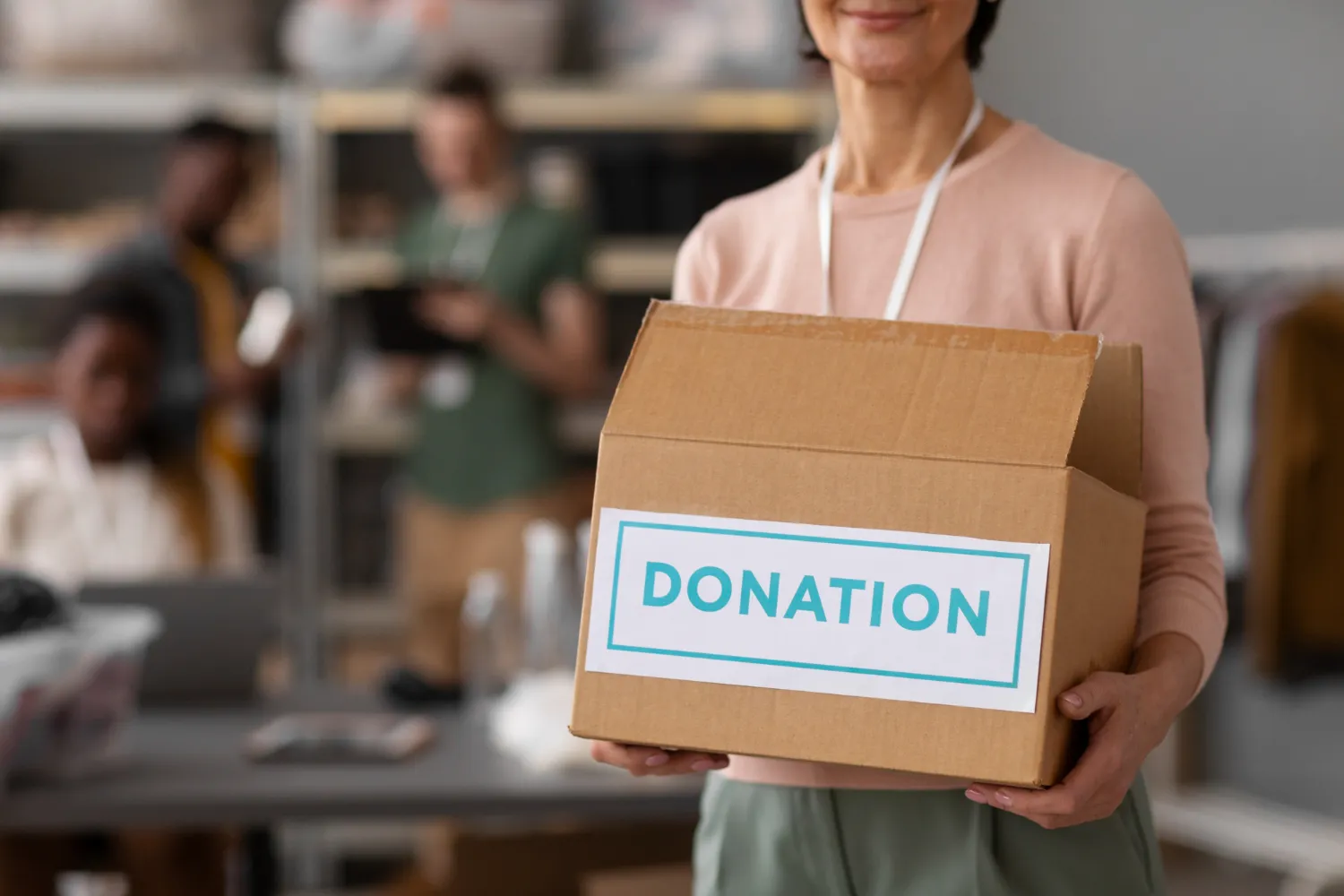 Volunteer helping with donation box<br />
